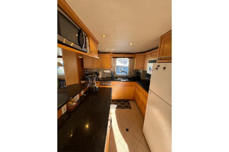 Evening Star Yacht Photos Pics Kitchen interior of 2003 Cape Horn Trawler with modern appliances and wooden cabinetry.