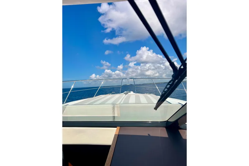  Yacht Photos Pics 2017 Riviera 445 SUV yacht cruising under a clear blue sky.