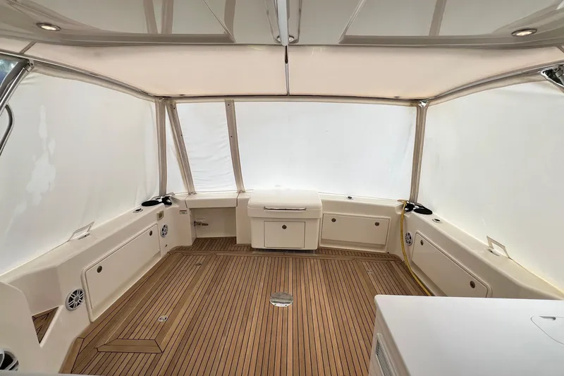  Yacht Photos Pics Interior of 2017 Riviera 445 SUV boat with teak flooring and enclosed seating area.