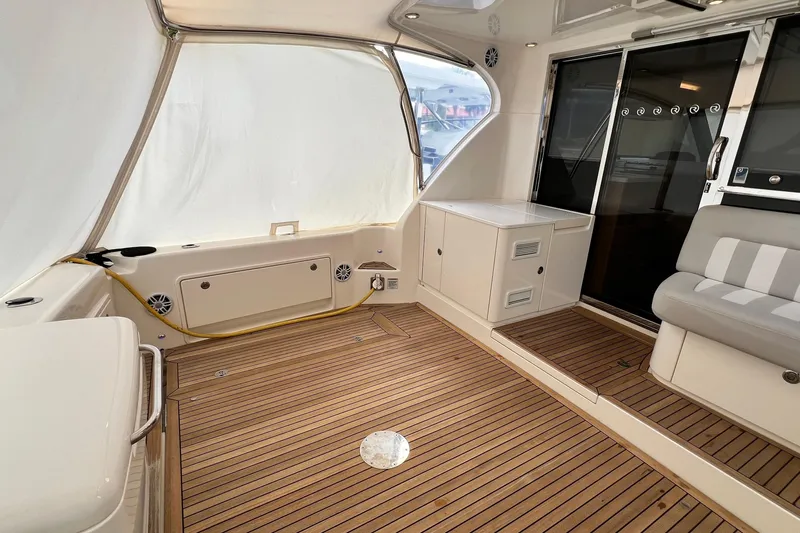  Yacht Photos Pics Interior of 2017 Riviera 445 SUV yacht with teak flooring and seating area.