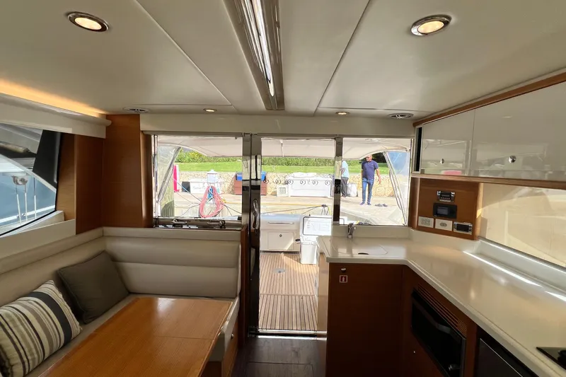  Yacht Photos Pics Interior of 2017 Riviera 445 SUV yacht with modern kitchen and seating area.