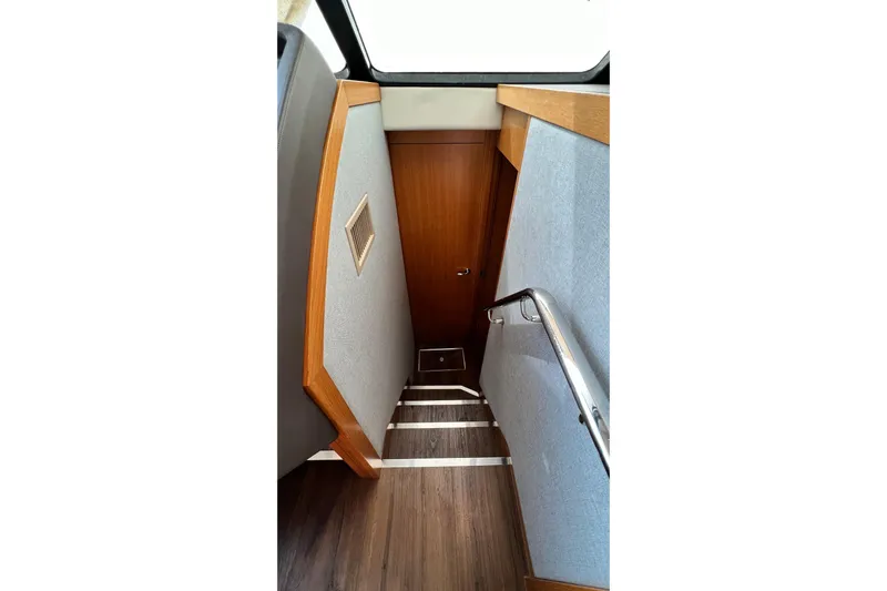  Yacht Photos Pics Staircase inside 2017 Riviera 445 SUV yacht with wooden and metal finishes.