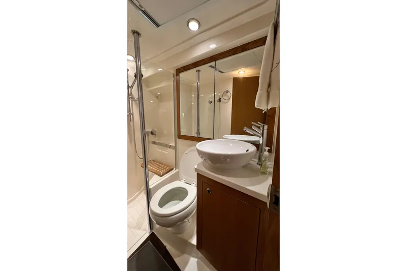  Yacht Photos Pics Luxurious bathroom in 2017 Riviera 445 SUV yacht with modern fixtures and elegant design.