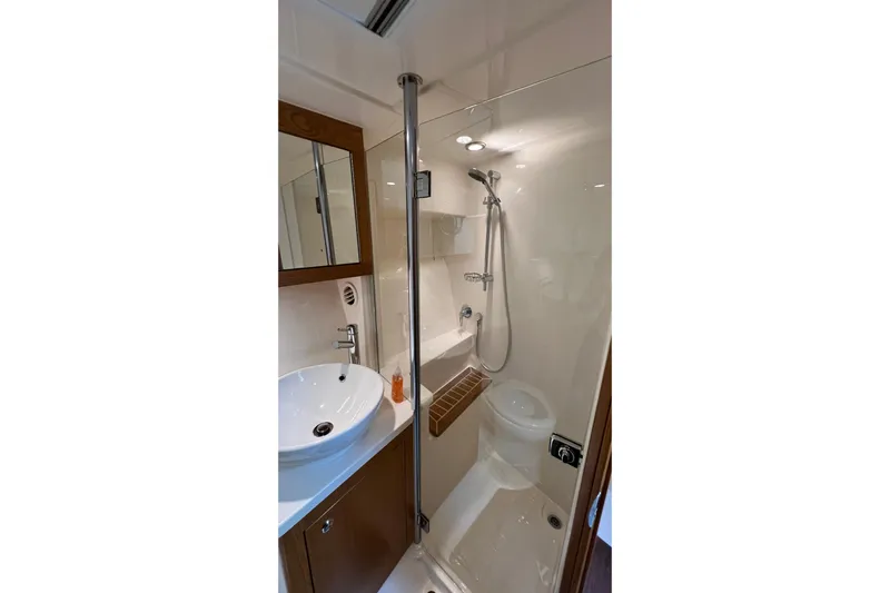  Yacht Photos Pics Compact bathroom in 2017 Riviera 445 SUV yacht with shower and sink.