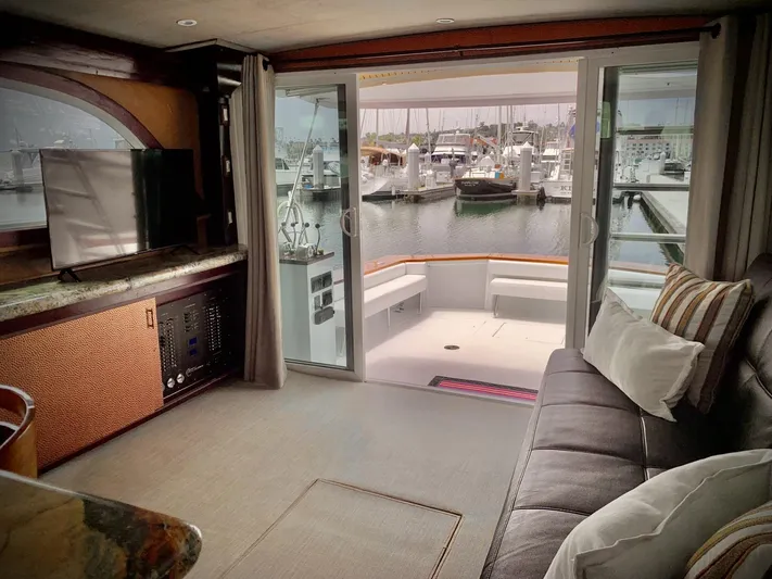  Yacht Photos Pics Interior of 1984 Egg Harbor 48 Flybridge Cruiser with marina view through sliding doors.