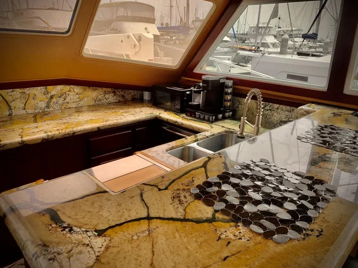  Yacht Photos Pics Luxurious kitchen interior of 1984 Egg Harbor 48 Flybridge Cruiser with granite countertops and marina view.