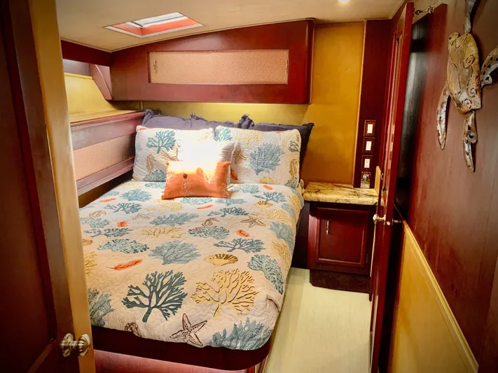  Yacht Photos Pics Cozy bedroom in 1984 Egg Harbor 48 Flybridge Cruiser with nautical-themed bedding.