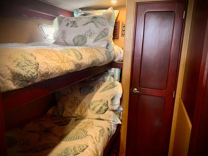  Yacht Photos Pics Bunk beds in 1984 Egg Harbor 48 Flybridge Cruiser with seashell-themed bedding.