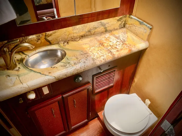  Yacht Photos Pics Luxurious bathroom in 1984 Egg Harbor 48 Flybridge Cruiser with marble countertop and modern fixtures.