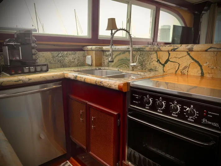  Yacht Photos Pics Luxurious kitchen in 1984 Egg Harbor 48 Flybridge Cruiser with marble countertops and modern appliances.