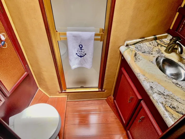  Yacht Photos Pics Luxurious bathroom in 1984 Egg Harbor 48 Flybridge Cruiser with granite countertop and wooden flooring.