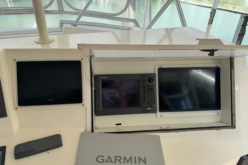 All In Yacht Photos Pics 1993 Viking 50 Convertible boat dashboard with Garmin and Furuno navigation displays.