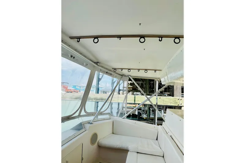 All In Yacht Photos Pics Interior view of 1993 Viking 50 Convertible yacht with white seating and windows.