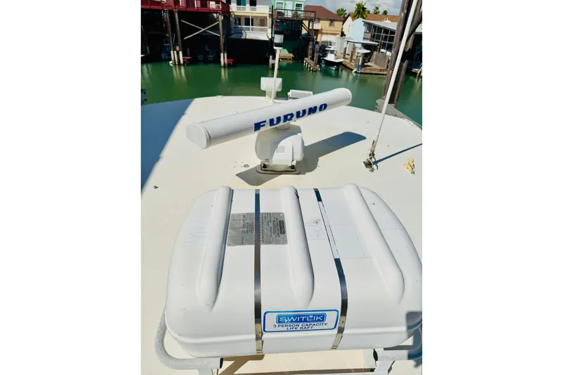 All In Yacht Photos Pics 1993 Viking 50 Convertible boat with radar and life raft on deck.