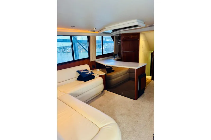 All In Yacht Photos Pics Interior of 1993 Viking 50 Convertible yacht with cream leather seating and wooden cabinetry.