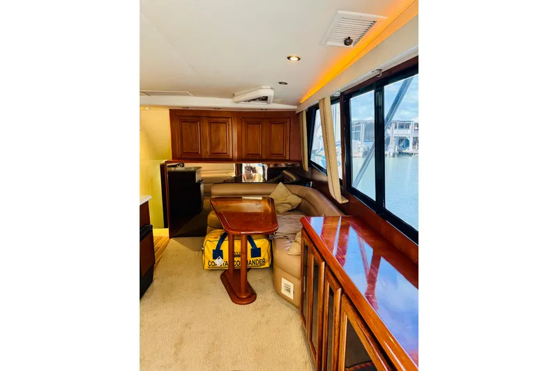 All In Yacht Photos Pics Interior of 1993 Viking 50 Convertible yacht with wooden cabinetry and large windows.
