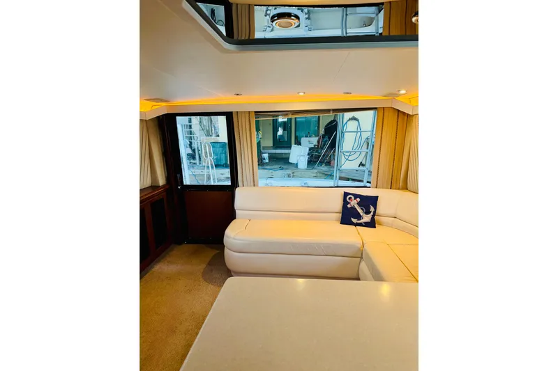 All In Yacht Photos Pics Interior of 1993 Viking 50 Convertible yacht with cream leather seating and anchor-themed pillow.
