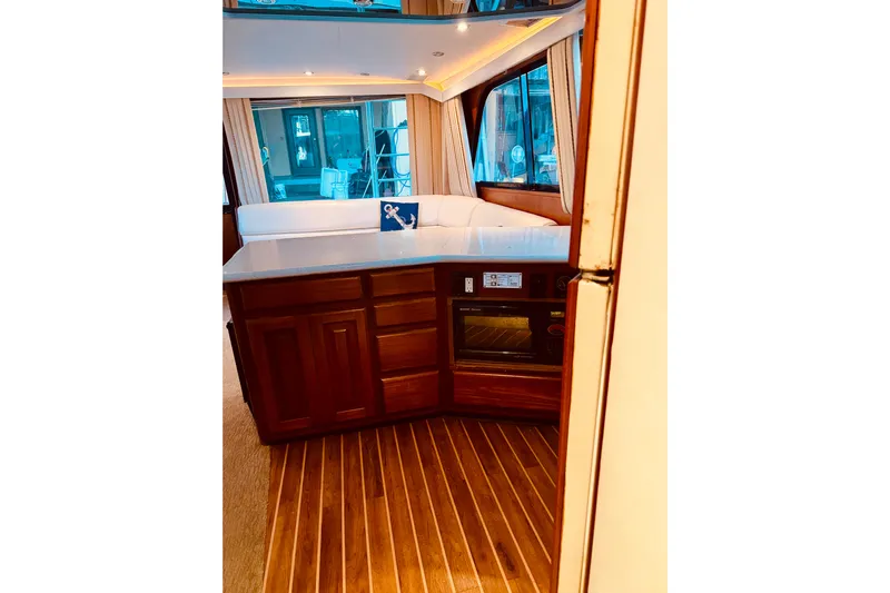 All In Yacht Photos Pics Interior of 1993 Viking 50 Convertible yacht with wood flooring and modern kitchen amenities.