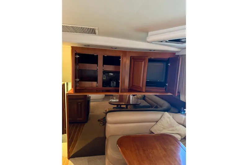 All In Yacht Photos Pics Interior of 1993 Viking 50 Convertible yacht with wooden cabinetry and cozy seating area.
