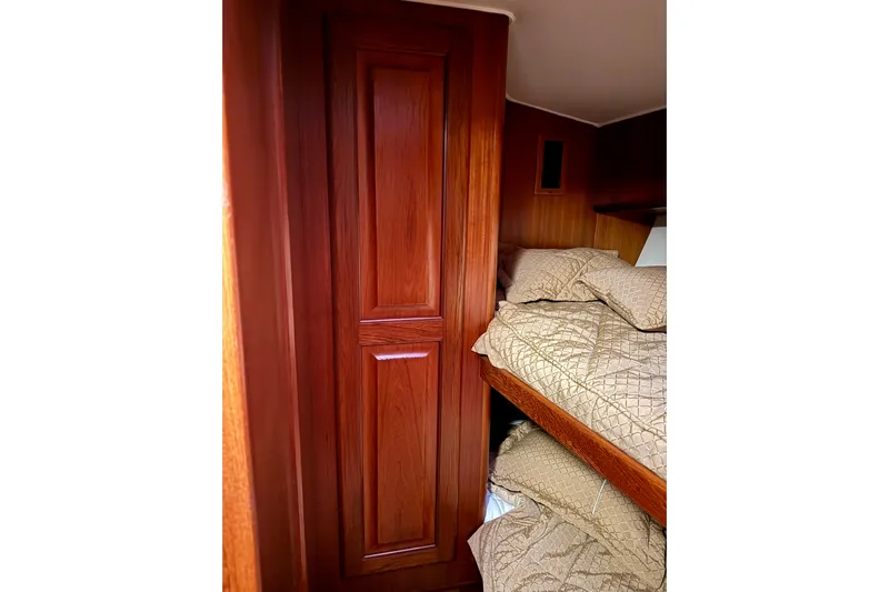 All In Yacht Photos Pics Interior of 1993 Viking 50 Convertible yacht with wooden cabinetry and cozy bunk beds.
