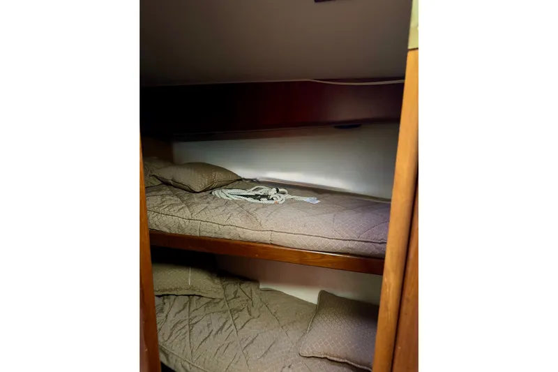 All In Yacht Photos Pics Bunk beds in 1993 Viking 50 Convertible yacht cabin with brown bedding.