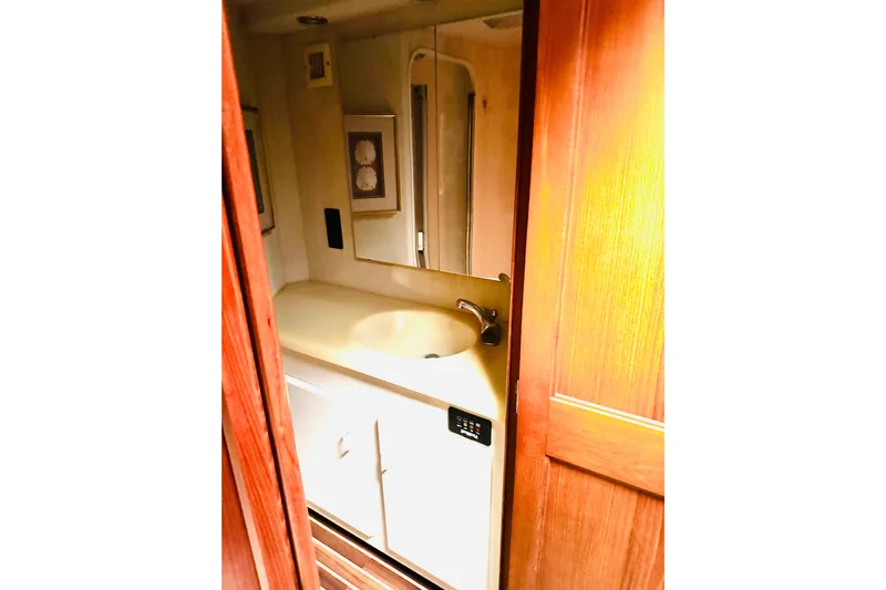 All In Yacht Photos Pics Bathroom interior of 1993 Viking 50 Convertible yacht with sink and mirror.