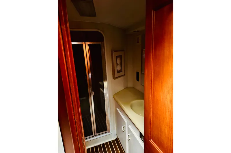 All In Yacht Photos Pics Bathroom interior of 1993 Viking 50 Convertible yacht with wooden accents and shower.