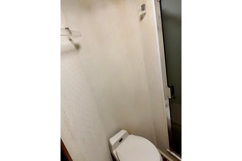 All In Yacht Photos Pics Bathroom interior of 1993 Viking 50 Convertible yacht, featuring toilet and shower.