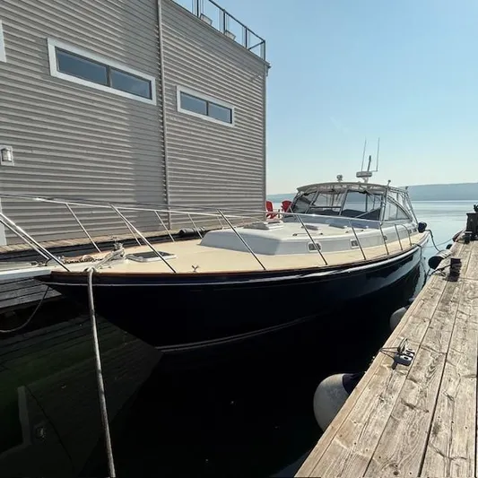  Yacht Photos Pics 1997 Little Harbor WhisperJet 46 docked beside a building on a sunny day.