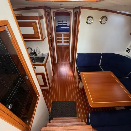  Yacht Photos Pics Interior of 1997 Little Harbor WhisperJet 46 yacht with wood flooring and cozy seating area.