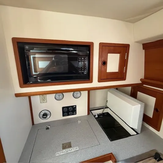  Yacht Photos Pics Interior of 1997 Little Harbor WhisperJet 46 with microwave, refrigerator, and wooden cabinetry.