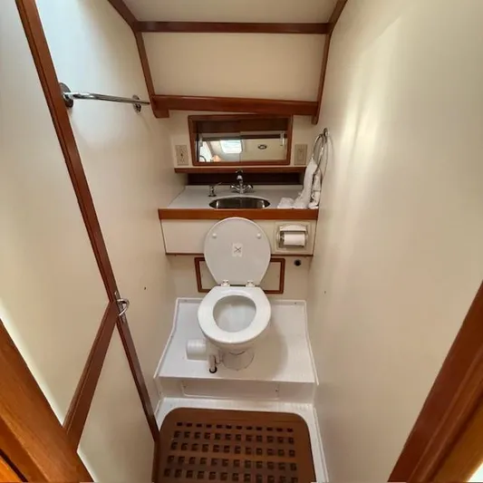  Yacht Photos Pics 1997 Little Harbor WhisperJet 46 yacht bathroom with toilet, sink, and wooden accents.