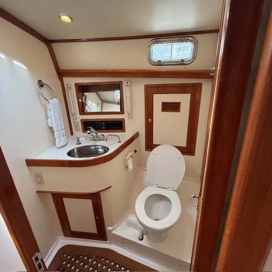  Yacht Photos Pics 1997 Little Harbor WhisperJet 46 yacht bathroom with sink, toilet, and wooden accents.