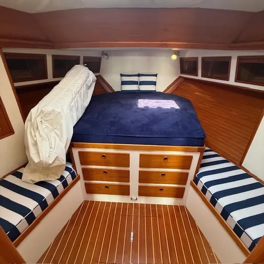  Yacht Photos Pics Cozy cabin interior of 1997 Little Harbor WhisperJet 46 with striped seating and wooden accents.