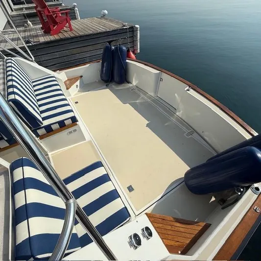  Yacht Photos Pics 1997 Little Harbor WhisperJet 46 boat with striped seating, docked by calm water.