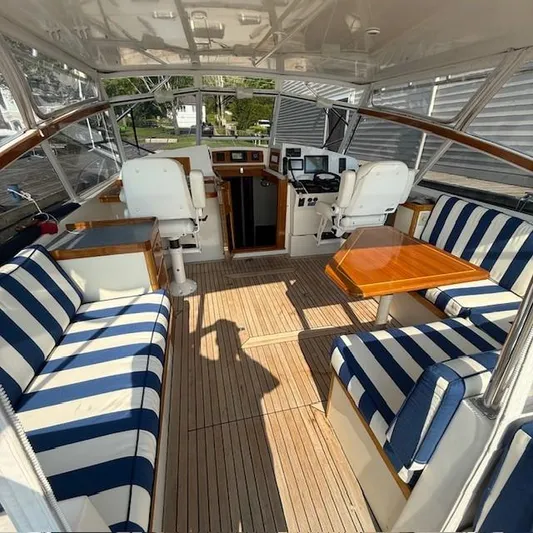  Yacht Photos Pics 1997 Little Harbor WhisperJet 46 interior with striped seating and wooden table.