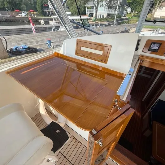  Yacht Photos Pics 1997 Little Harbor WhisperJet 46 helm station with polished wood finish and marina view.