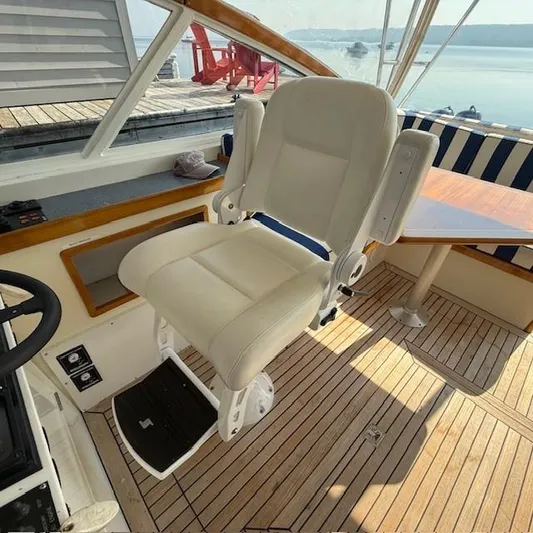 Yacht Photos Pics Captain's chair on 1997 Little Harbor WhisperJet 46 yacht, featuring teak flooring and helm station.