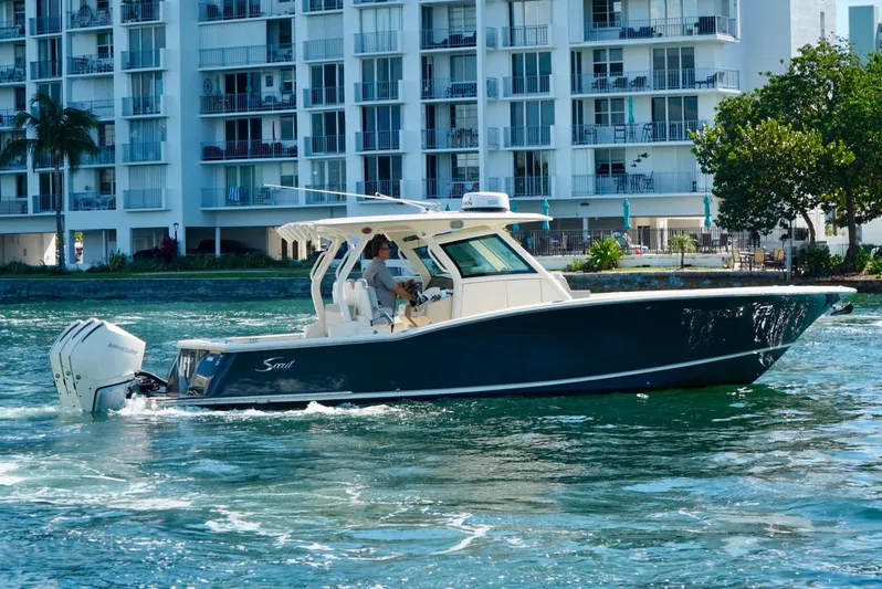 Af1 Yacht Photos Pics 2019 Scout 355 LXF boat cruising near waterfront buildings.