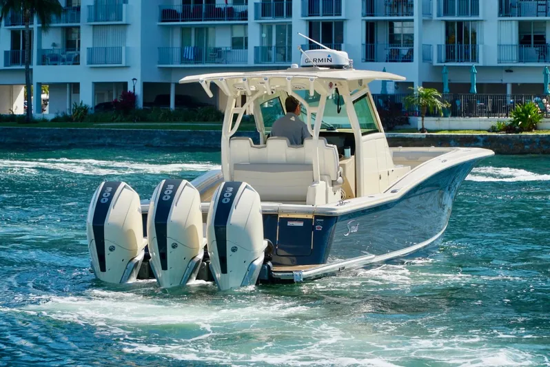 Af1 Yacht Photos Pics 2019 Scout 355 LXF boat with triple engines cruising near waterfront buildings.