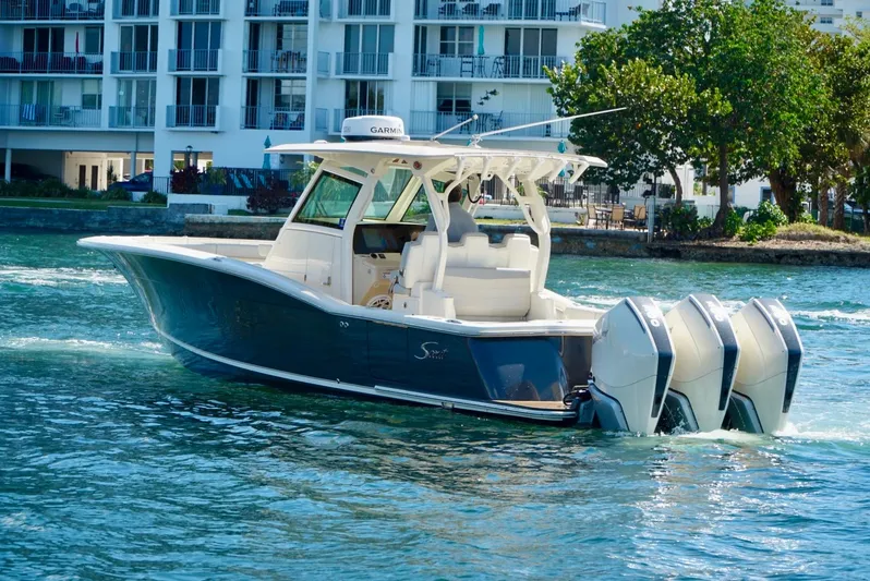 Af1 Yacht Photos Pics 2019 Scout 355 LXF boat with triple engines cruising near waterfront buildings.