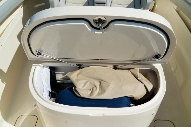 Af1 Yacht Photos Pics Open storage compartment on 2019 Scout 355 LXF boat with items inside.