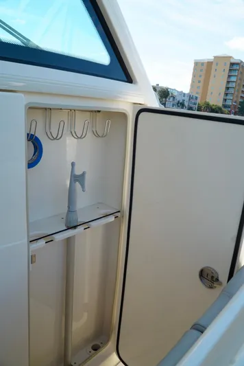 Af1 Yacht Photos Pics 2019 Scout 355 LXF boat storage compartment with hooks and a hose.