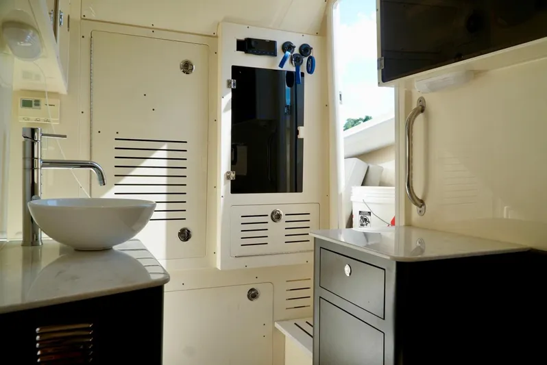 Af1 Yacht Photos Pics 2019 Scout 355 LXF boat interior with modern sink and storage cabinets.
