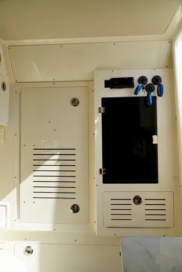 Af1 Yacht Photos Pics 2019 Scout 355 LXF boat interior panel with storage compartments and controls.