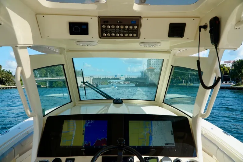 Af1 Yacht Photos Pics Cockpit view of 2019 Scout 355 LXF boat navigating through a waterway.