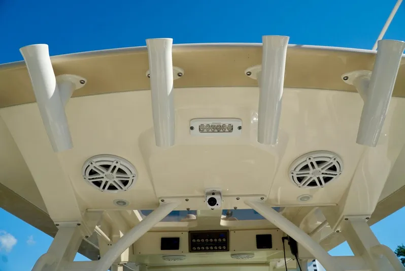 Af1 Yacht Photos Pics 2019 Scout 355 LXF boat roof with rod holders and speakers against blue sky.