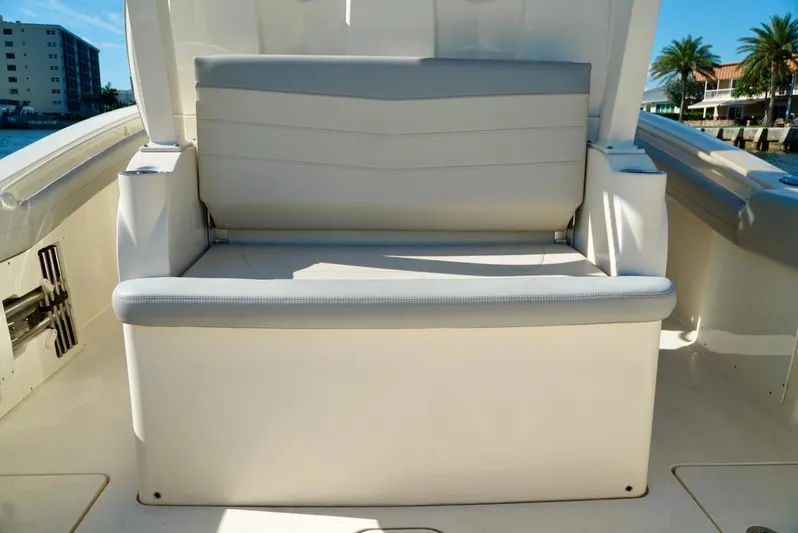 Af1 Yacht Photos Pics 2019 Scout 355 LXF boat seating area with white cushioned bench.