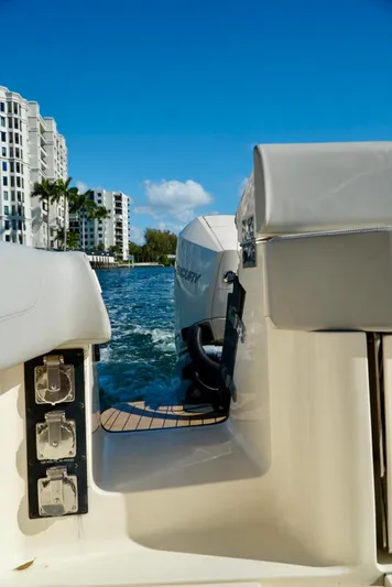 Af1 Yacht Photos Pics 2019 Scout 355 LXF boat on water, cityscape background, clear blue sky.