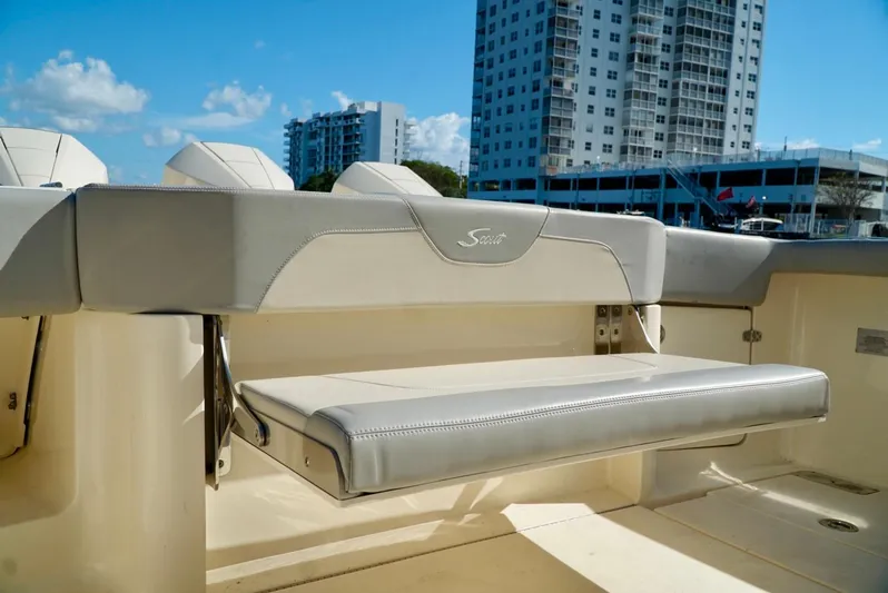 Af1 Yacht Photos Pics 2019 Scout 355 LXF boat interior with foldable seat, urban skyline background.